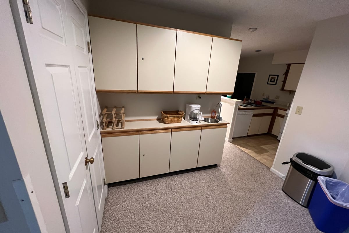 The kitchen before renovation — dated laminate cabinets