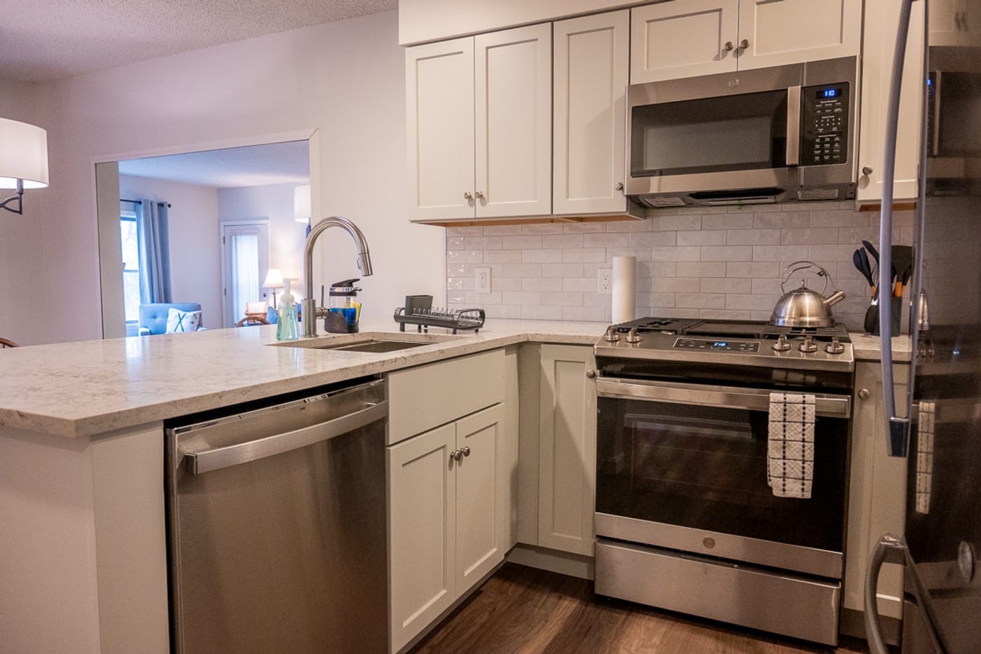 The renovated kitchen — grey shaker cabinets and stainless appliances